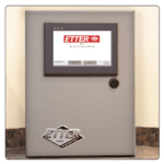 IntelliWorx: HMI mounted in a control panel with terminals and other components.