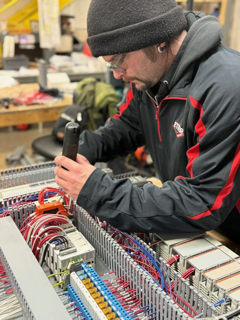 photo of ETTER engineer working on control panel