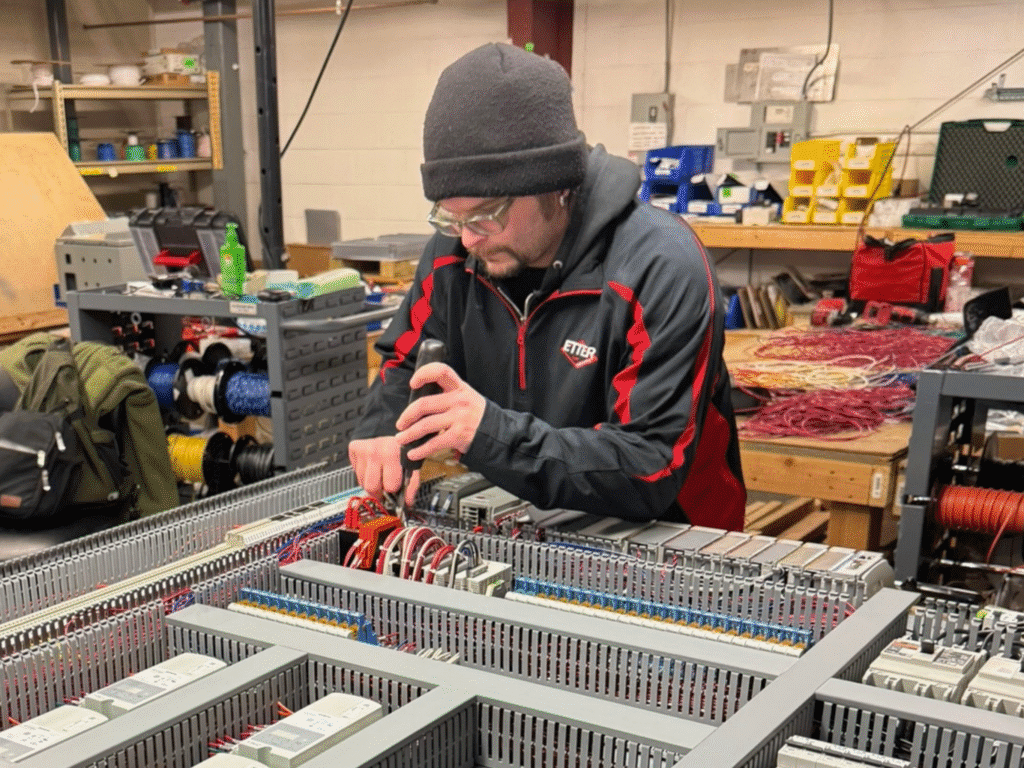 Photo of ETTER Engineering employee working on electrical fabrication.