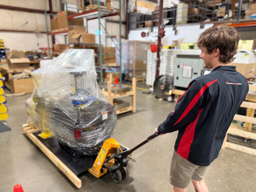 Jeremy moving a KPak booster with a pallet jack