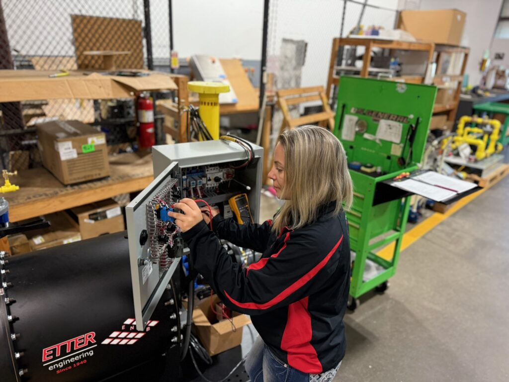 Quality Control & Assurance: Sammi checking out a booster KPak prior to shipping.